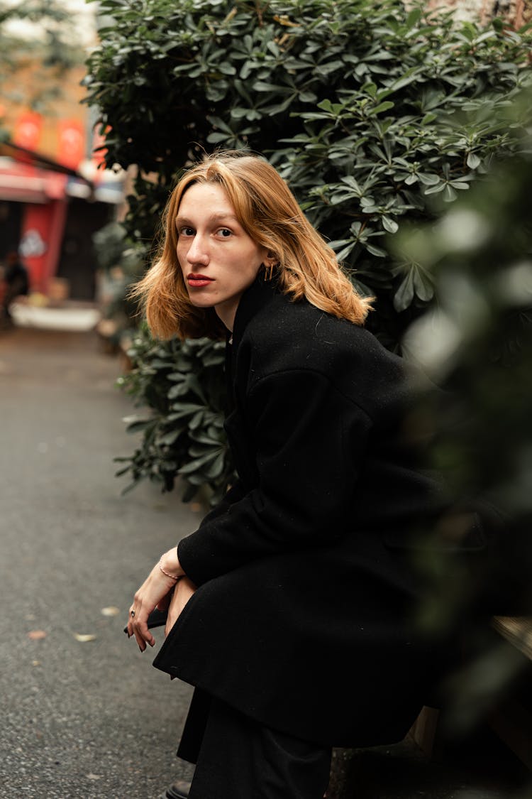 Woman Sitting On A Bench On A Park