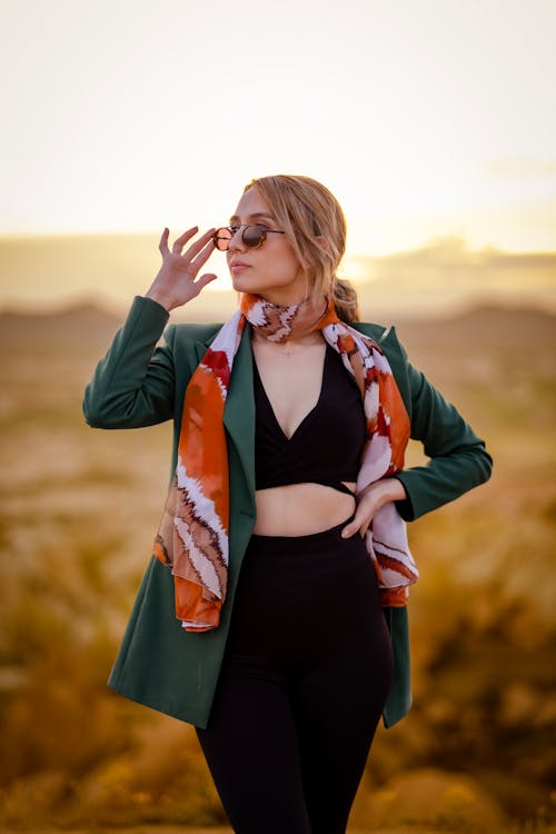 Model in a Green Blazer and Scarf Over a Black Crop Top and Leggings