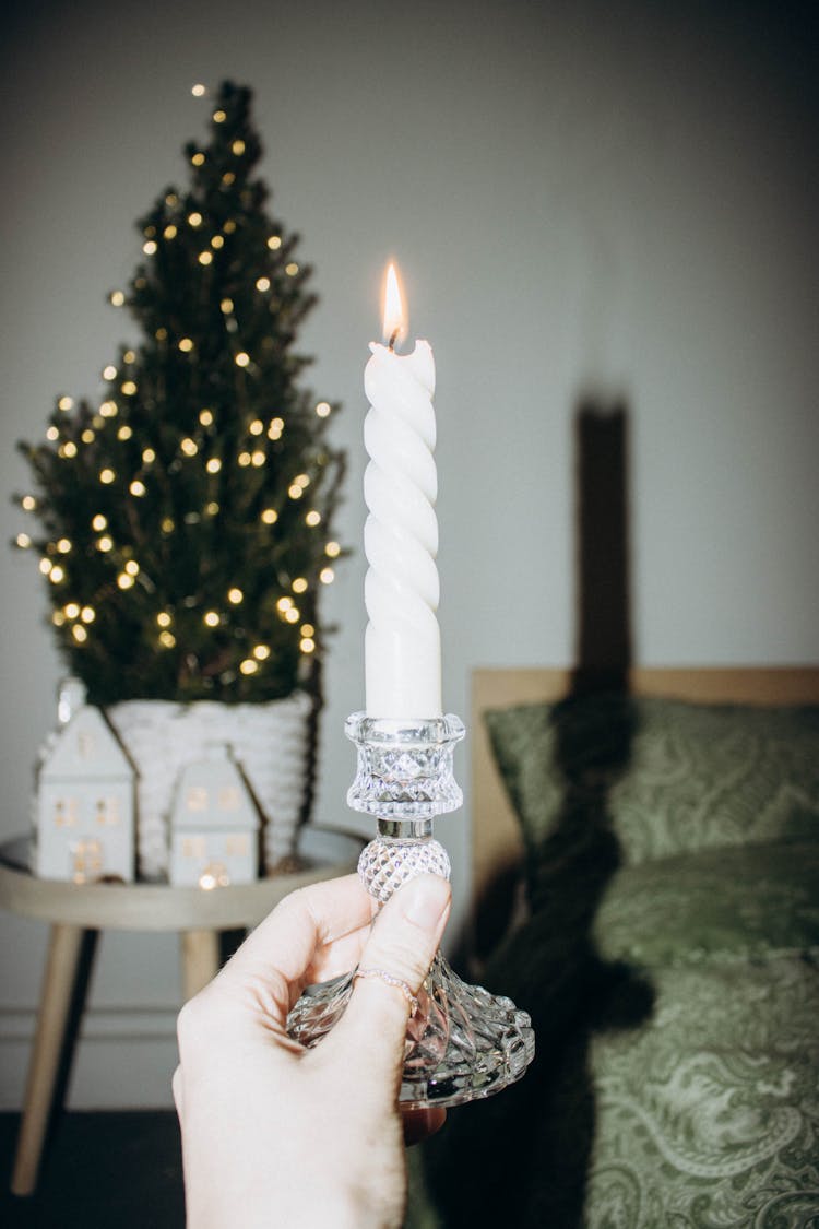 Candle Stick In Front Of A Christmas Tree