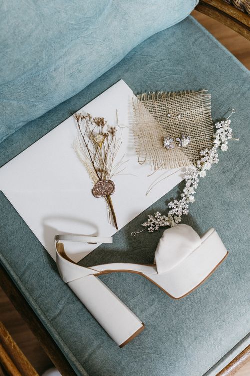 Free A stylish composition of wedding accessories including shoes and jewelry on a cushion. Stock Photo