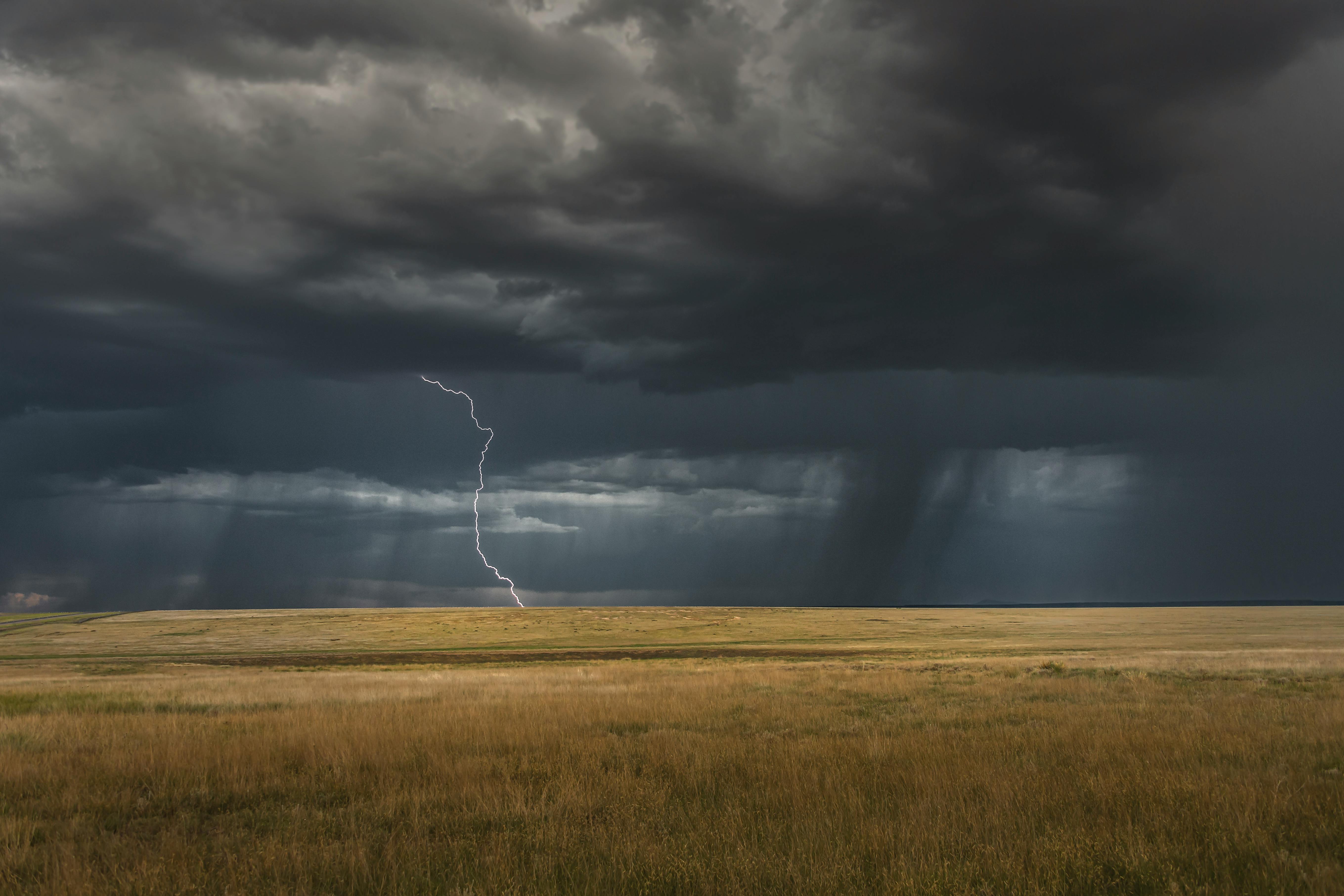 Intense lightning storm over a vast rural landscape in Wagon Mound, NM.