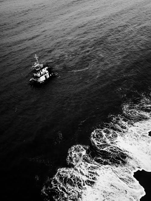 Boat and Waves in a Sea in Black and White