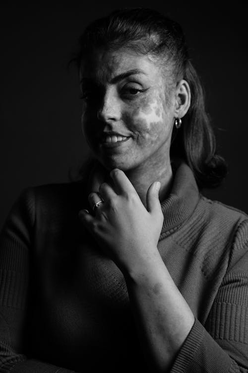 Black and White Portrait of a Woman in a Turtleneck Smiling 