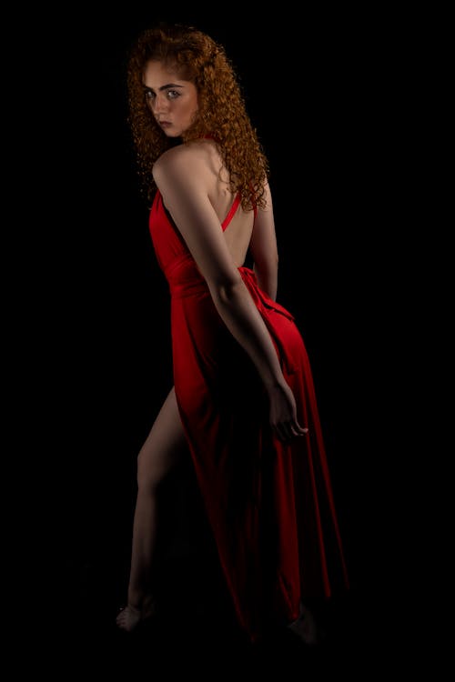 Darmowe zdjęcie z galerii z czarne tło, czerwona sukienka, fotografia mody