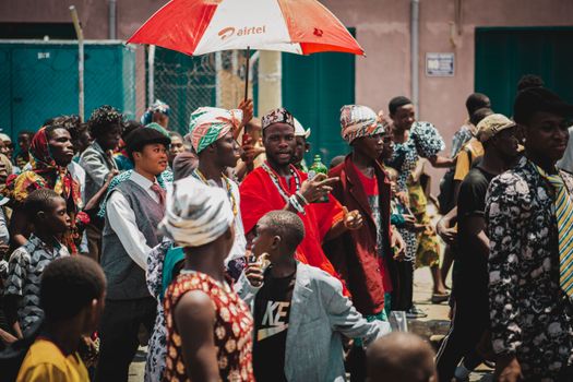 A lively street gathering in Accra, showcasing colorful traditional attire.