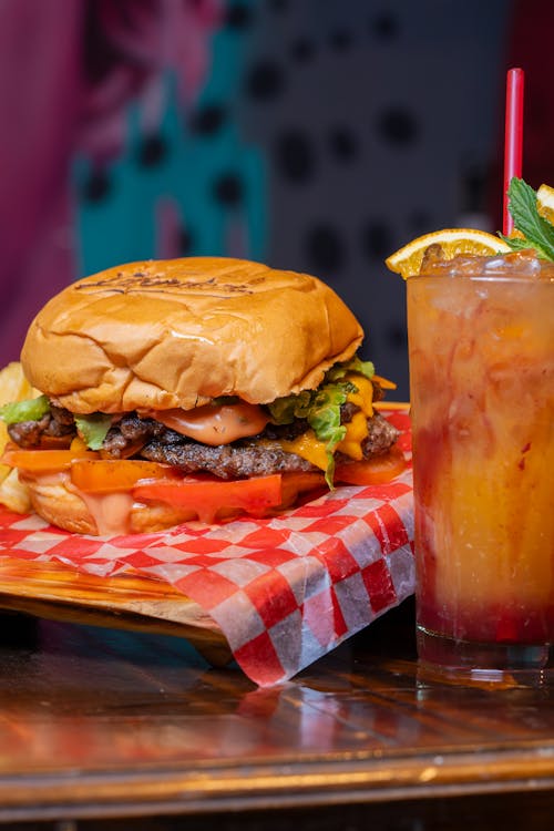 Close-up of a Burger and a Drink Served in a Restaurant 