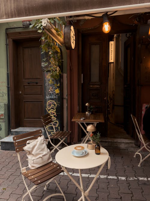 Coffee on the Table Standing on the Pavement Outside of a Cafe 