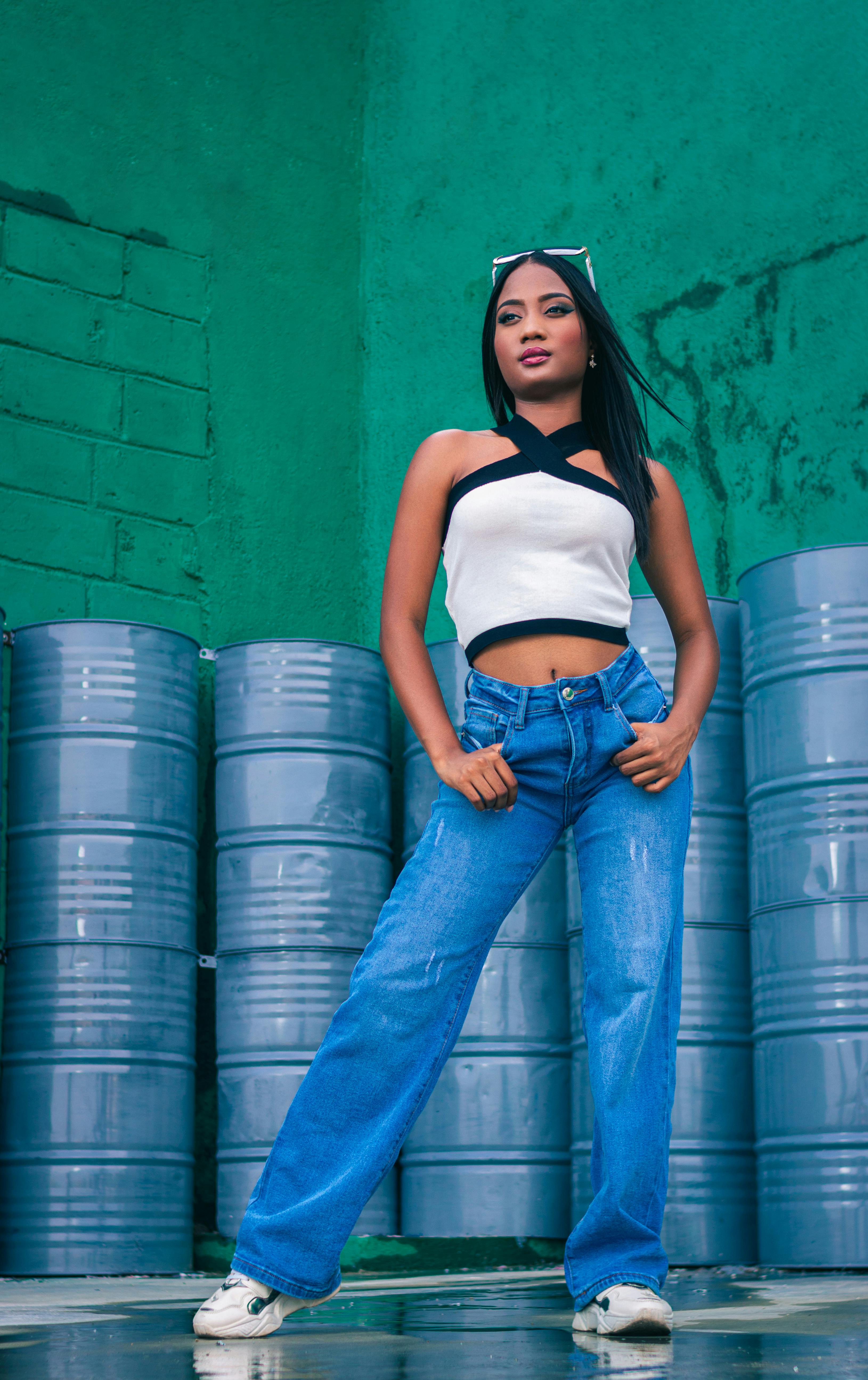 Woman in a Crop Top Leaning on a Railing · Free Stock Photo