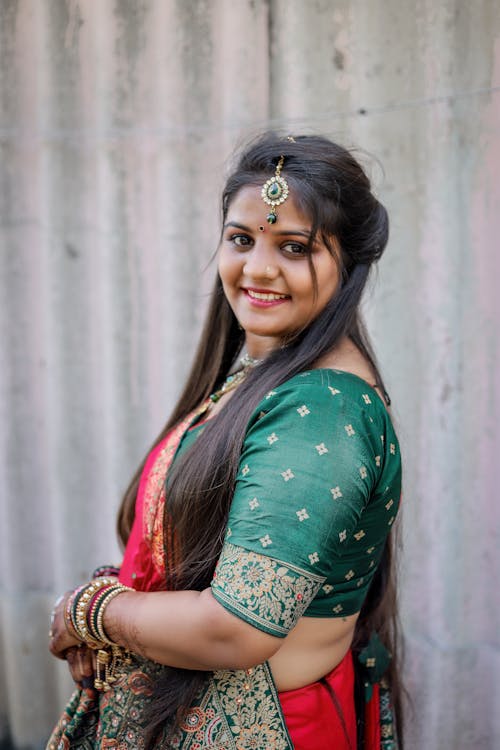 Photo of a Smiling Brunette Wearing a Sari