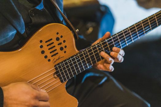 Musician skillfully playing an electric guitar with focus on hands and strings.. pexels, musician, skillfully