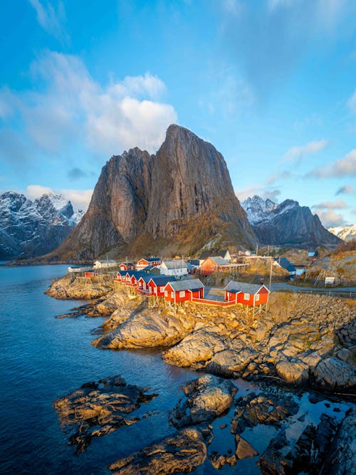 Rocky Mountain behind Village on Sea Shore