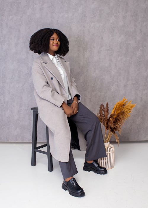 Elegant Woman Sitting Wearing Coat