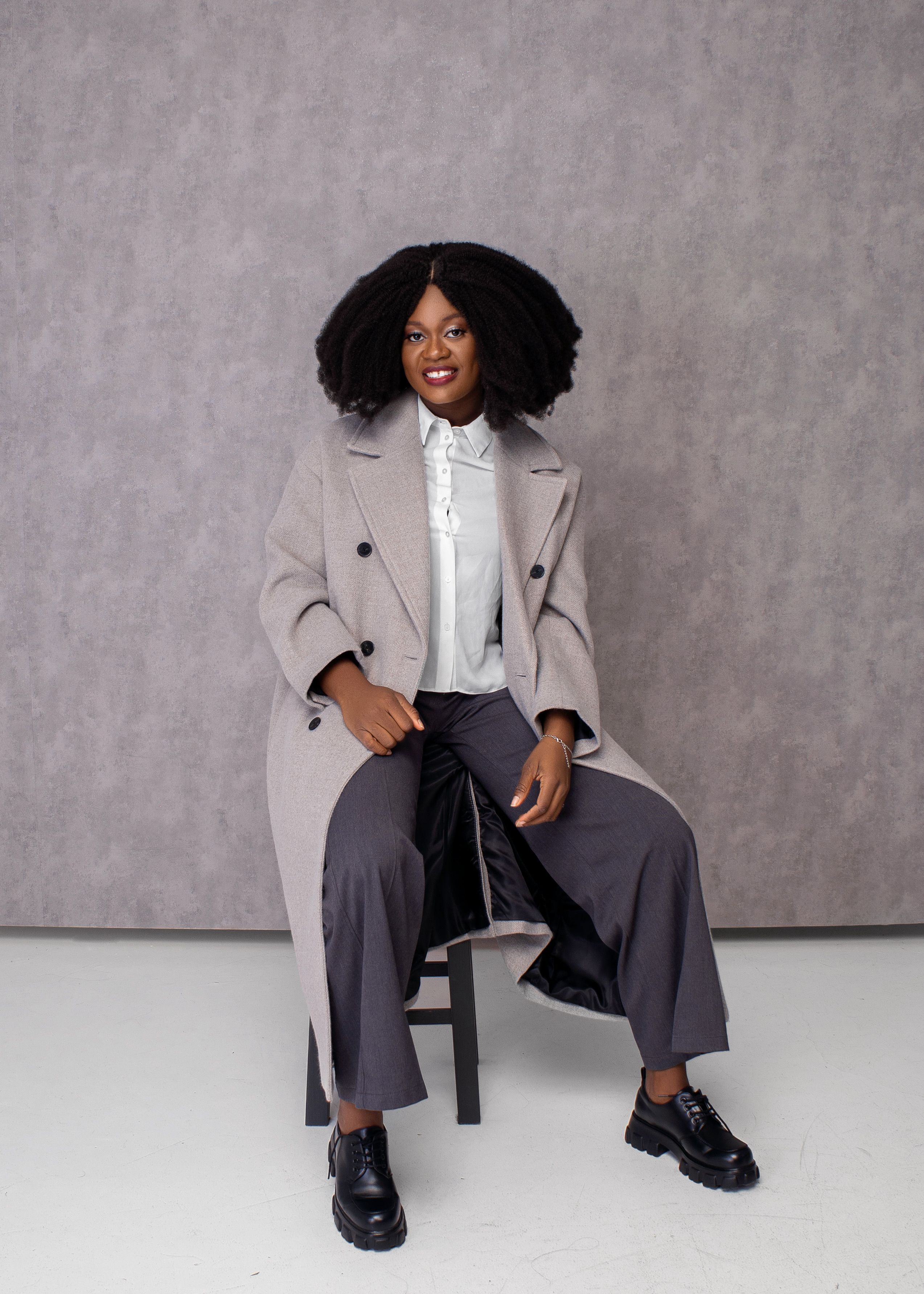 Woman in Trench Coat Sitting on Chair · Free Stock Photo