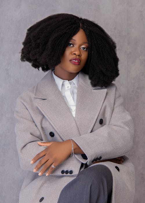 Elegant Woman Sitting Wearing Coat