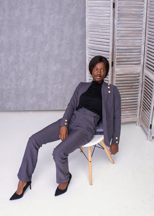 Woman in Gray Suit Sitting on Chair