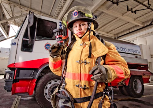 Firefighter with Pipe on Arm in Firehouse