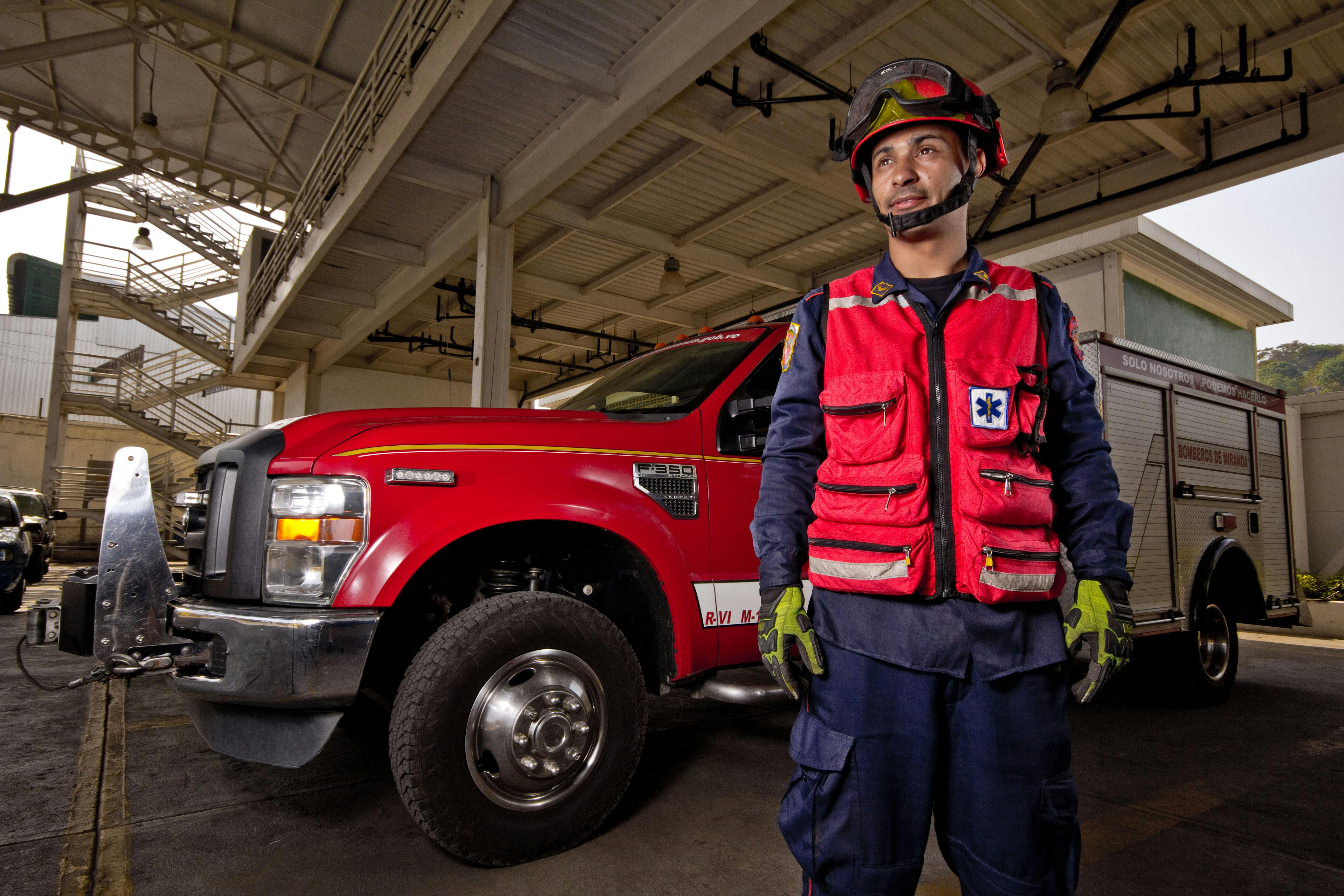 firefighter next to fire engine pickup truck