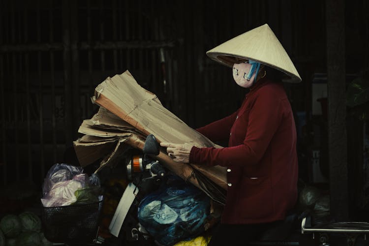 Woman On Motorcycle With Cardboard