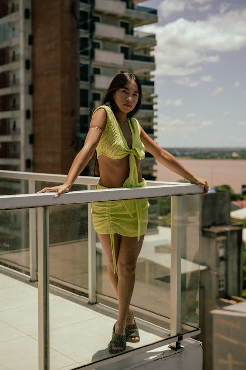 Woman Wearing Summer Clothes Standing on a Terrace in a City