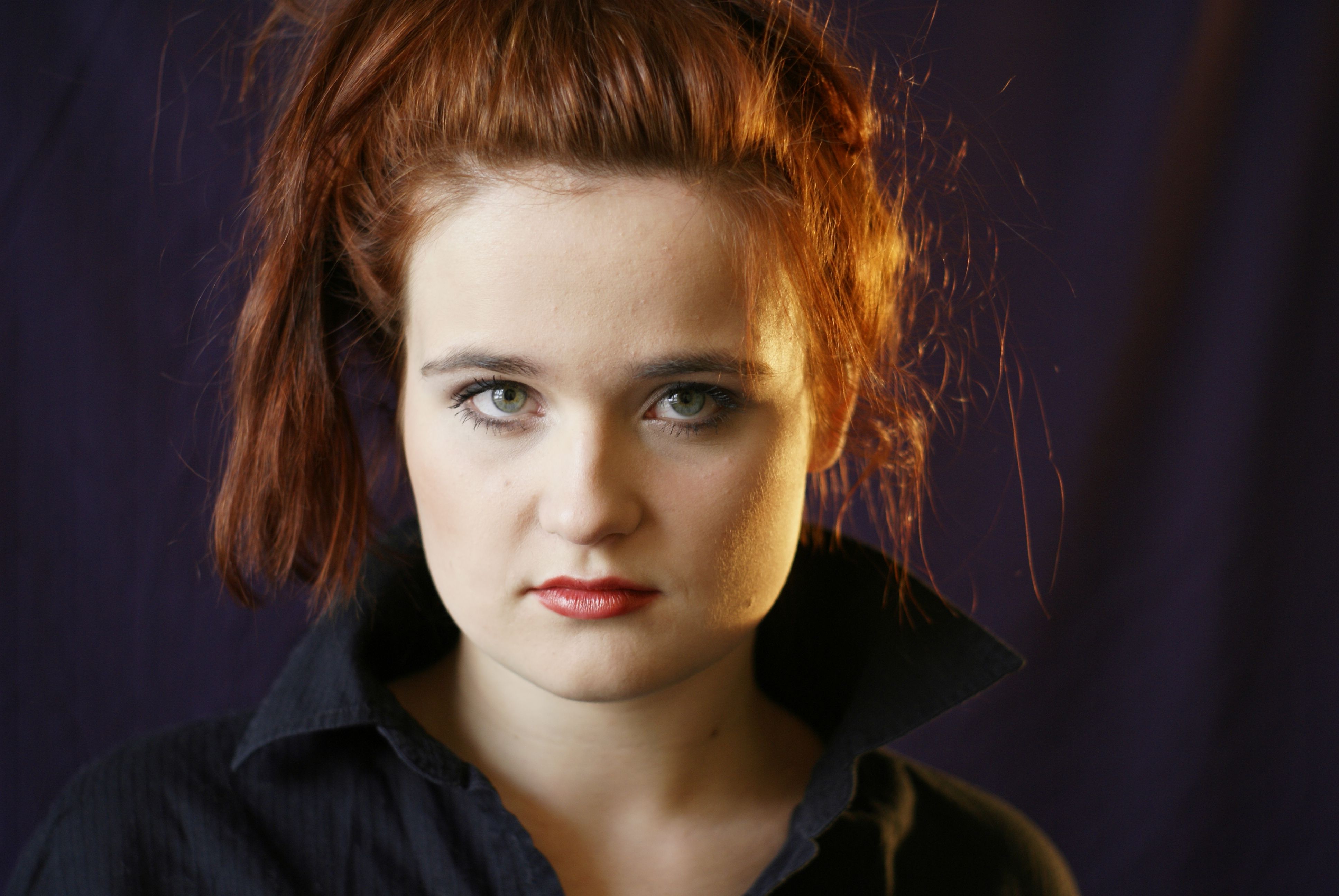 A woman with red hair and a black shirt · Free Stock Photo