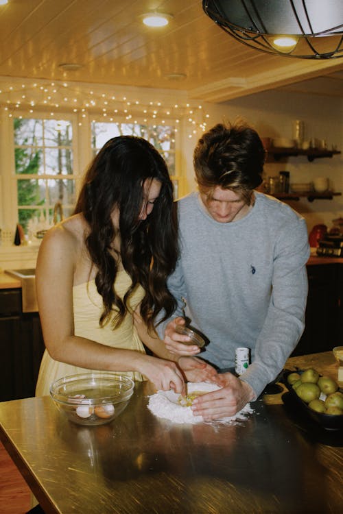Woman and a Man Making a Cake Together