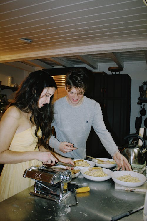 Woman and Man Putting Food on the Plates