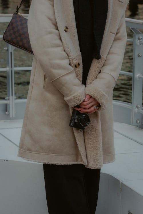 Woman in Winter Coat Holding Camera