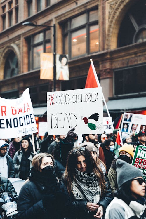 Crowd of Protesters with Banners Walking on the Street