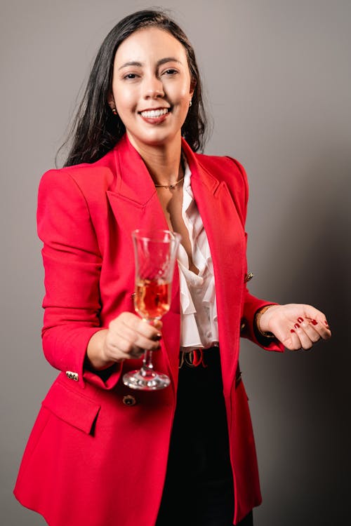 Woman in Red Jacket Holding Glass of Wine