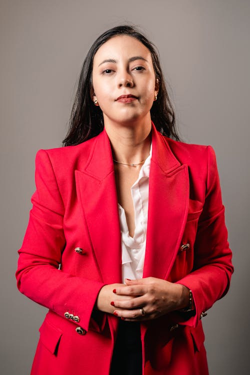 Woman in Red Jacket with Folded Hands