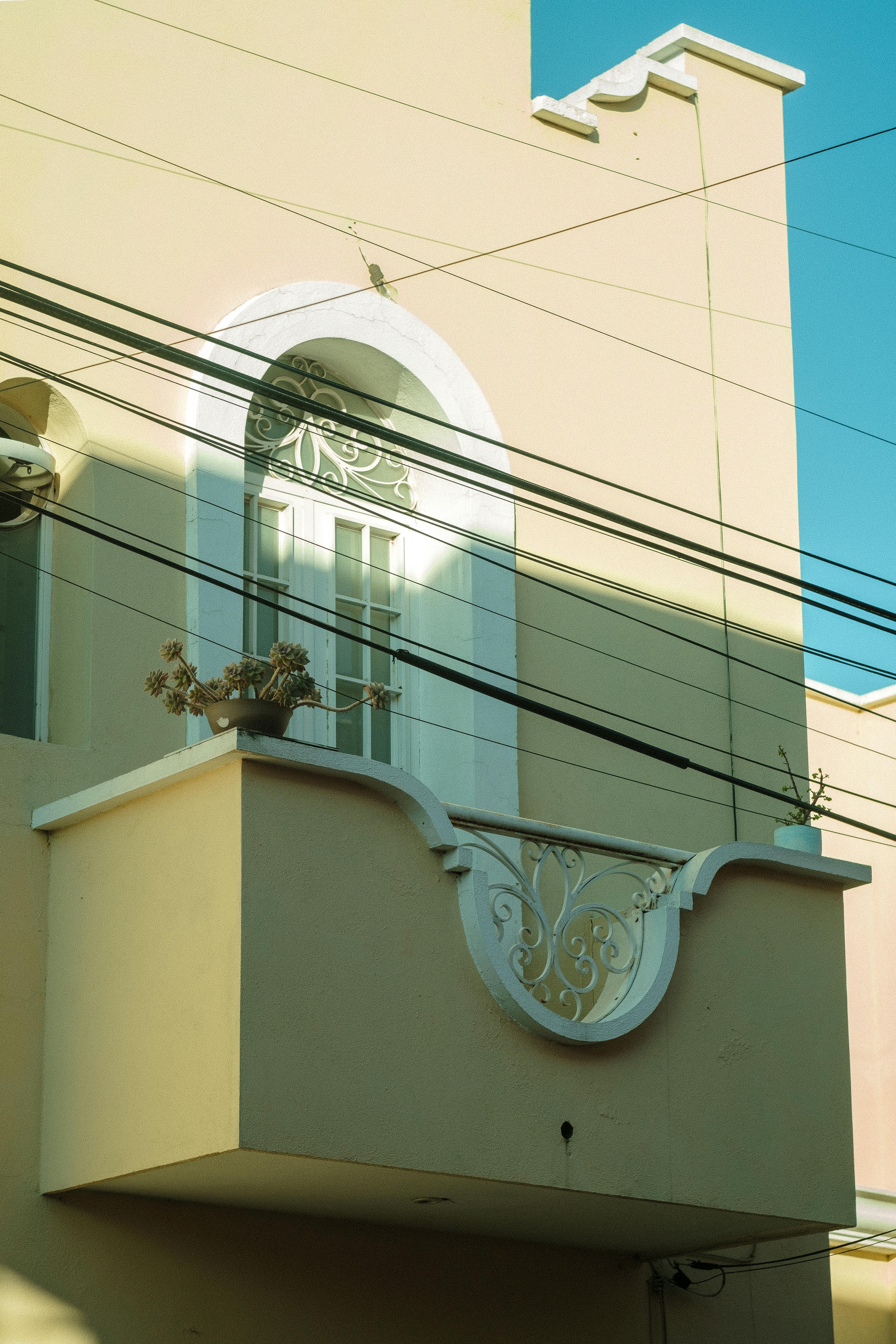 Elegant balcony with intricate details in a building facade, Aguascalientes, Mexico.