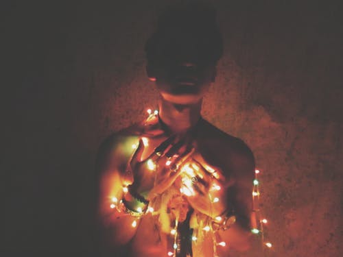 Free Man With Wrapped String Lights Stock Photo