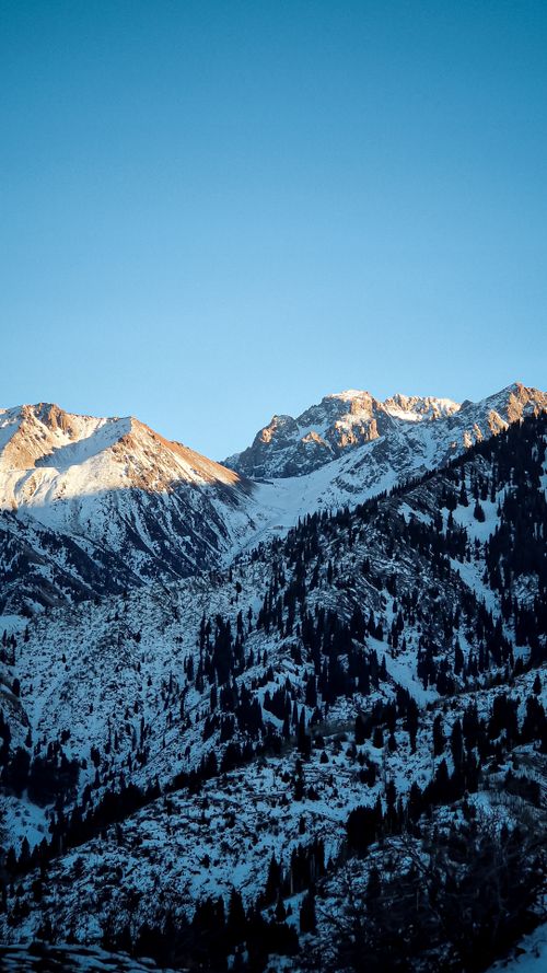 Free Stunning view of snow-capped mountains under a clear sky in Almaty, Kazakhstan. Stock Photo