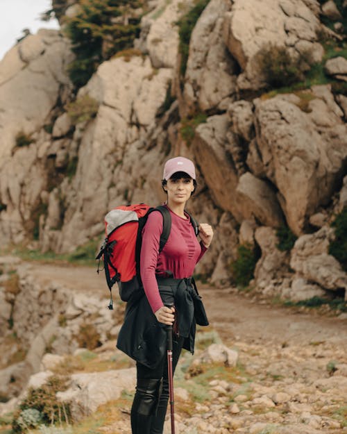 Woman in Cap and with Backpack Hiking