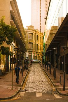A picturesque narrow alley with cobblestone pavement in a warm urban setting.