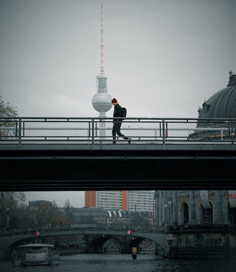 Man Walking On A Bridge In Berlin 