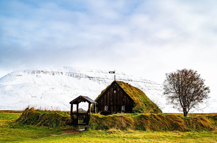 Wooden House Near Hill In Snow In Iceland