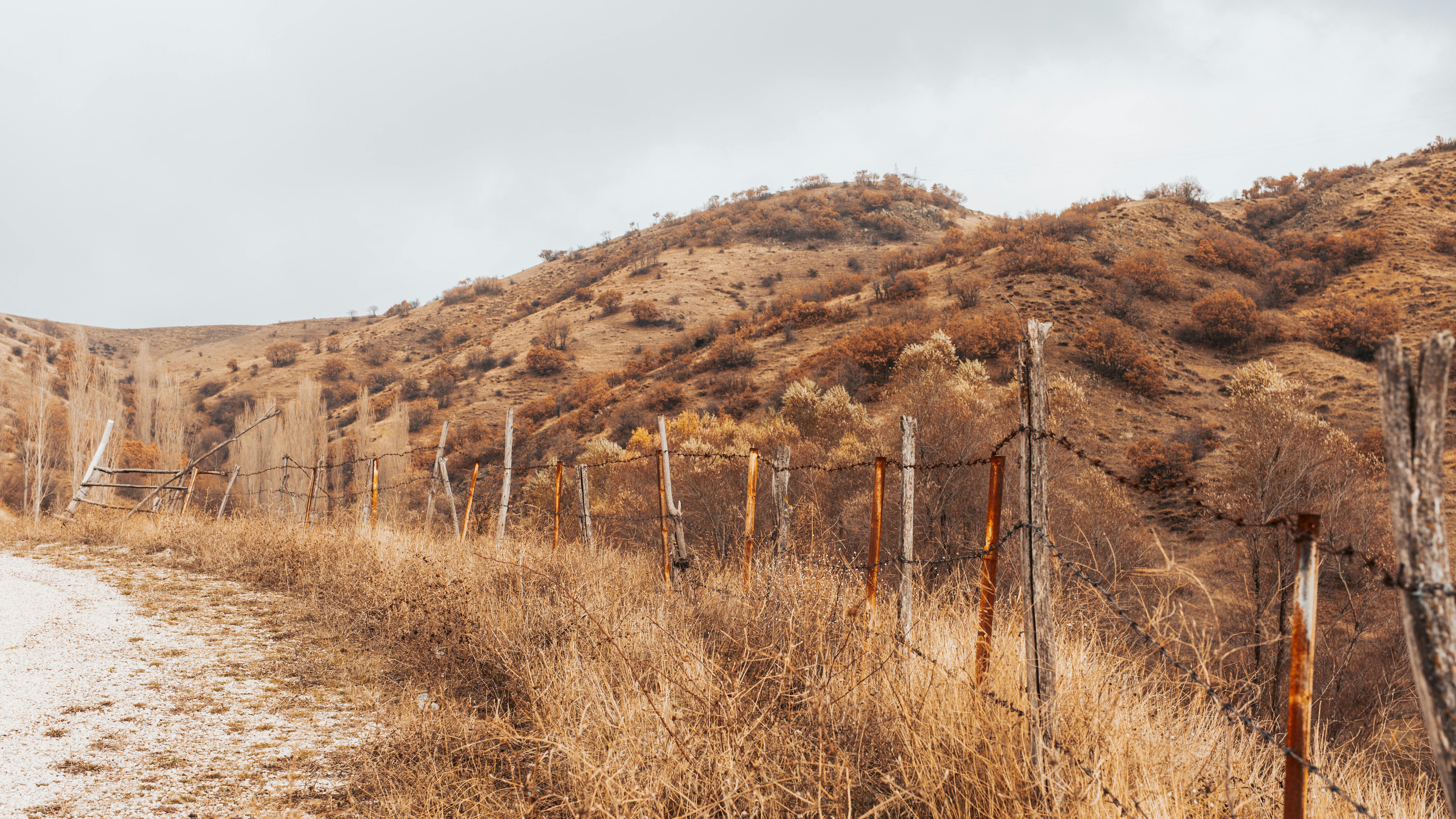 barbed wire fence installed on a steep, challenging terrain - barbed wire fence cost