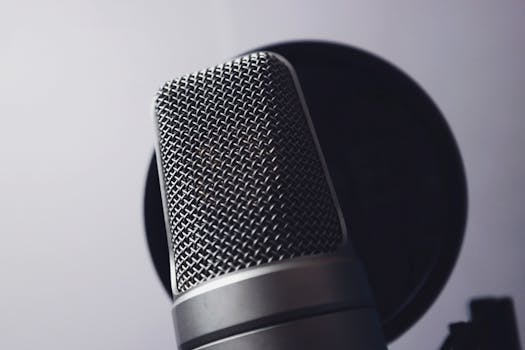 A close-up of a professional microphone in a studio. Ideal for music and broadcasting themes.
