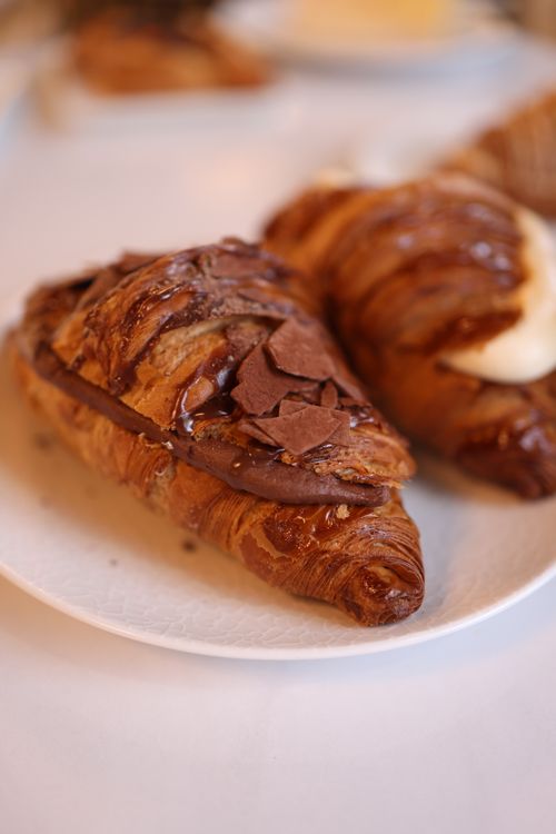 Free Close-up of chocolate croissants with cream filling on a white plate, showcasing rich textures. Stock Photo