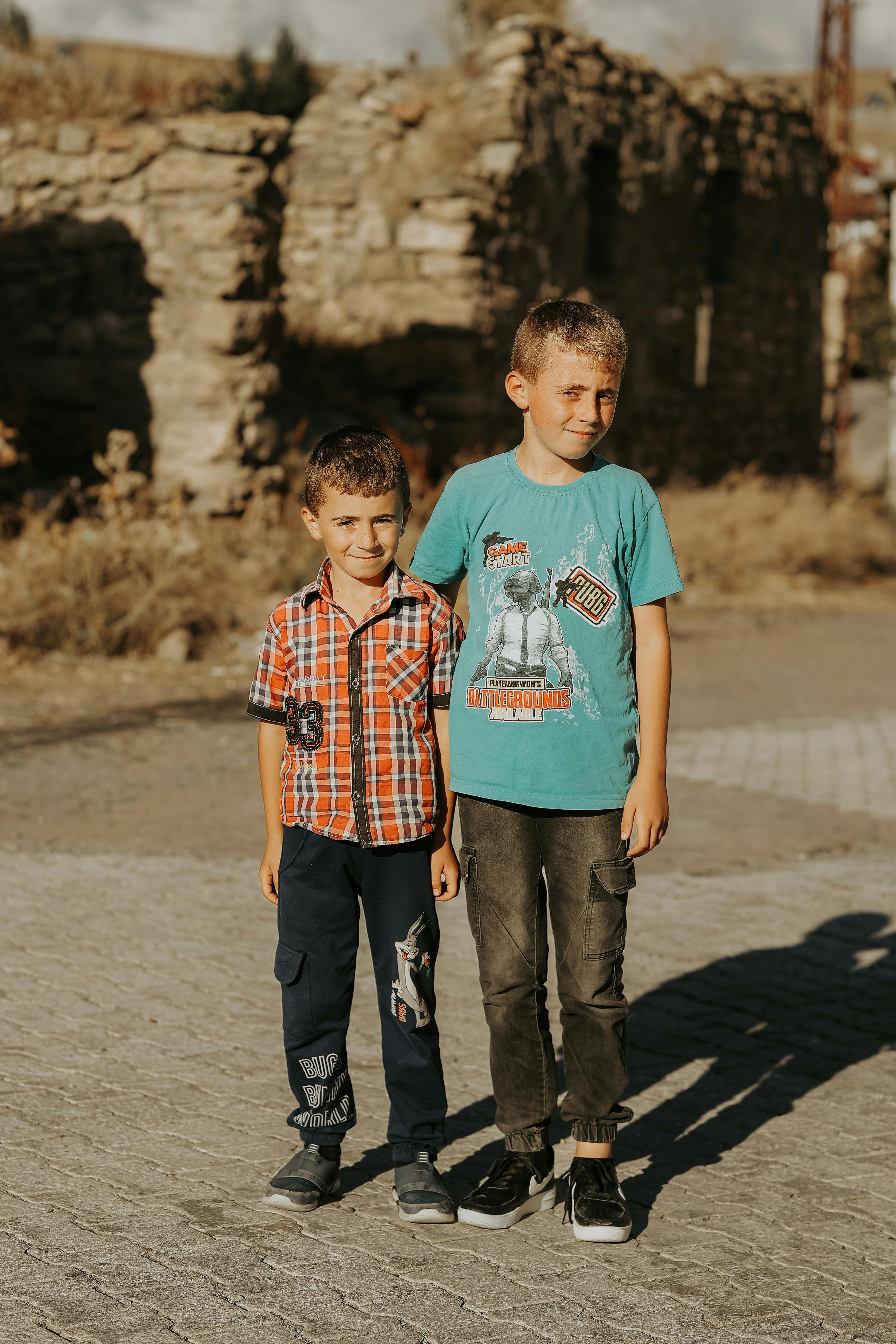 Brothers Posing for a Photo Near the Ruins · Free Stock Photo