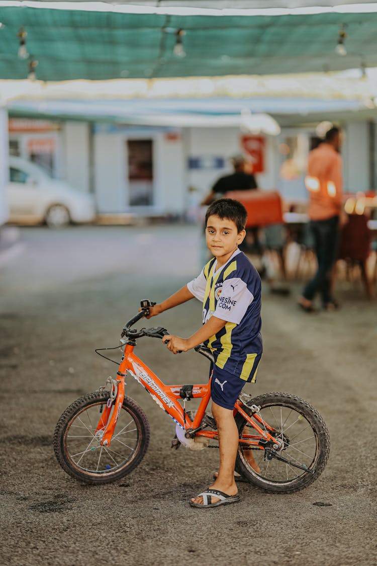 Boy With Bike In Town