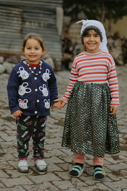 Two Little Girls Standing Outside and Holding Hands 