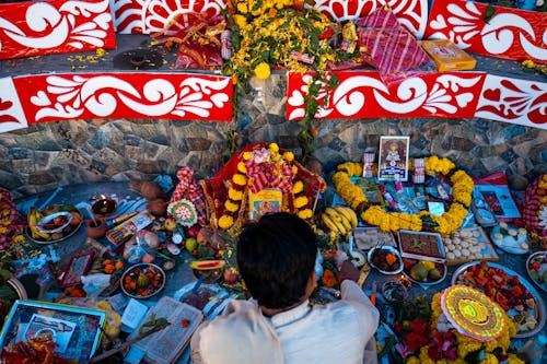 Man Praying at Buddhist Food Offering Altar