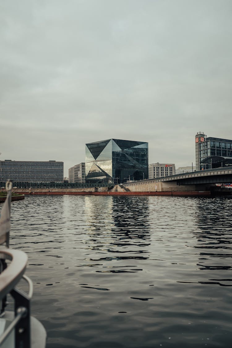 River And Modern Cube Building Behind