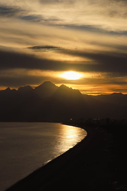 Golden Sunset Over the Mountains on the Seashore