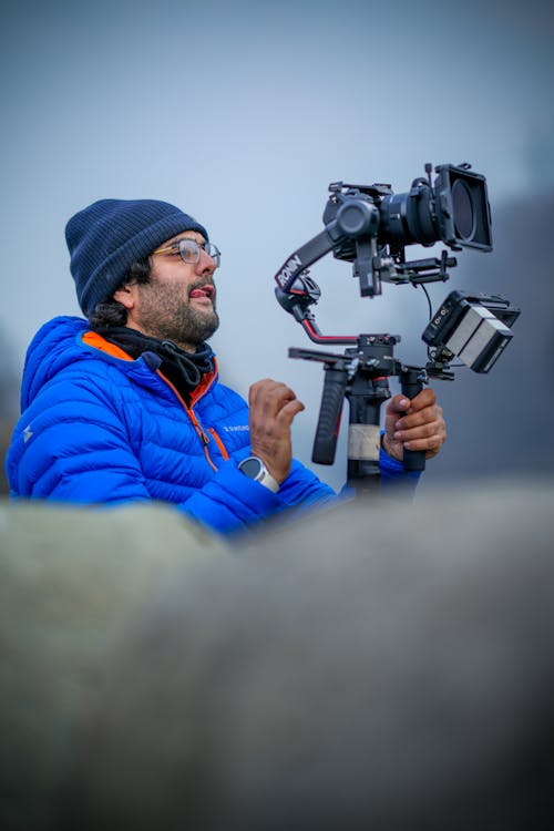 Man with Professional Camera on Tripod · Free Stock Photo