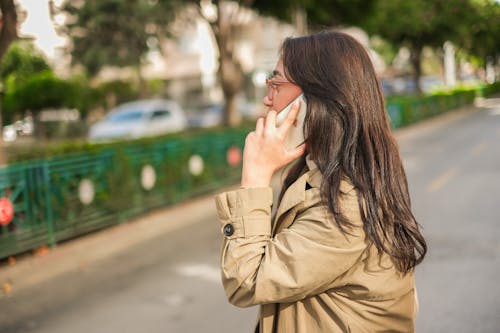 Woman Talking on a Phone on a Street 