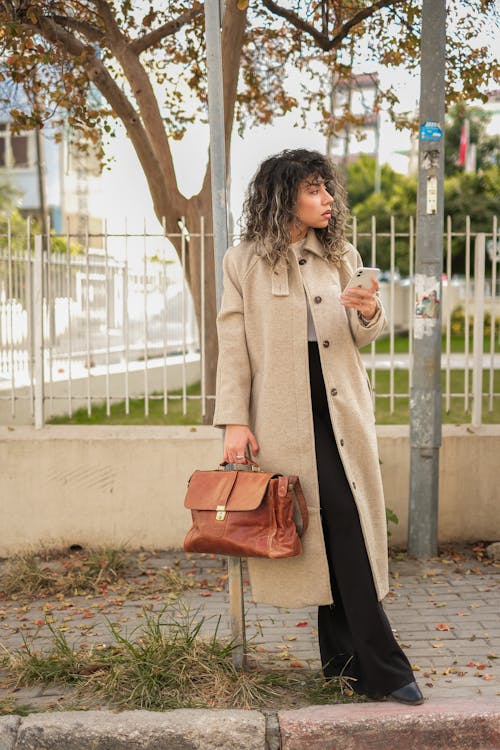 Woman Wearing Trench Coat on a Street