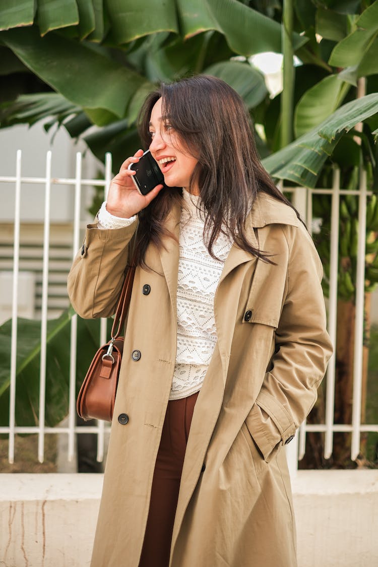 Young Woman Standing And Talking On The Phone